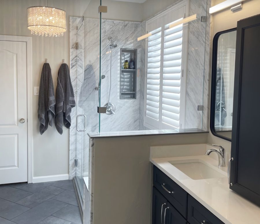 Bathroom after renovation — Carrara marble walk-in shower, custom vanity